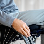 close up mid section view of a man sitting in a wheelchair